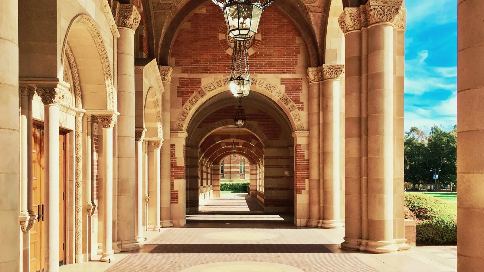 A view of the dark red, brown, and orange bricked arches of Royce Hall at UCLA.