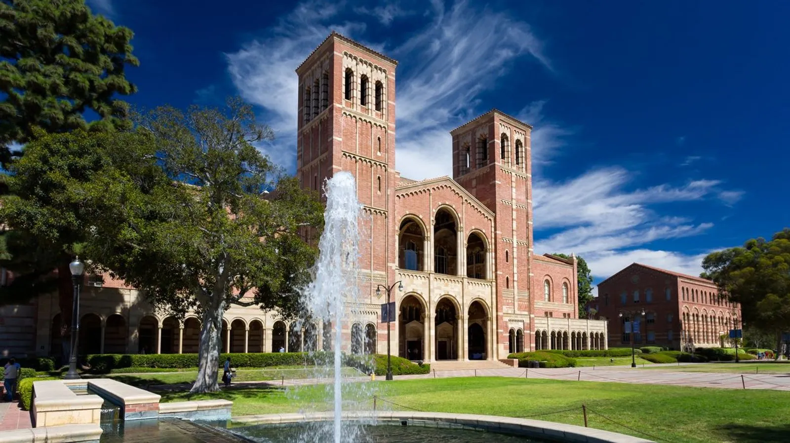 A view of UCLA's Royce Hall on a summer day, foregrounded by a fountain.
