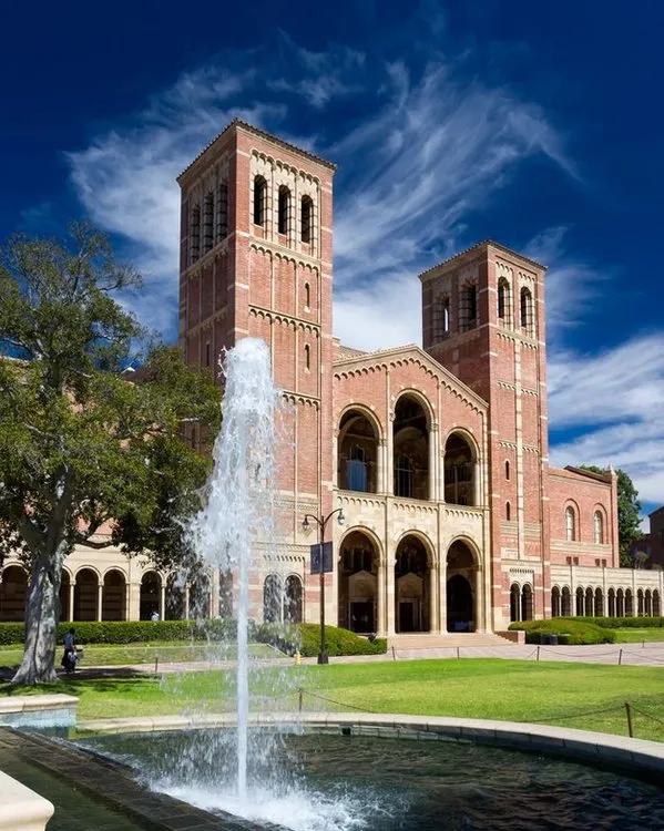 A view of UCLA's Royce Hall on a summer day, foregrounded by a fountain.